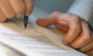 Man's Hands Signing Document