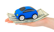 Hand with money and toy car