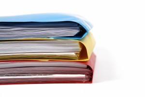 stack of colorful binders in a office