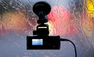 Vehicle DVR on glass of car in rain lights reflection