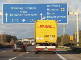 international parcel service DHL truck, drives on german freeway