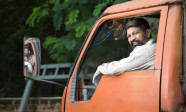 Happy truck driver looking over shoulder