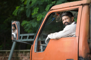 Happy truck driver looking over shoulder