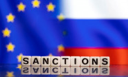 Illustration shows letters arranged to read "Sanctions" in front of EU and Russia's flag colors